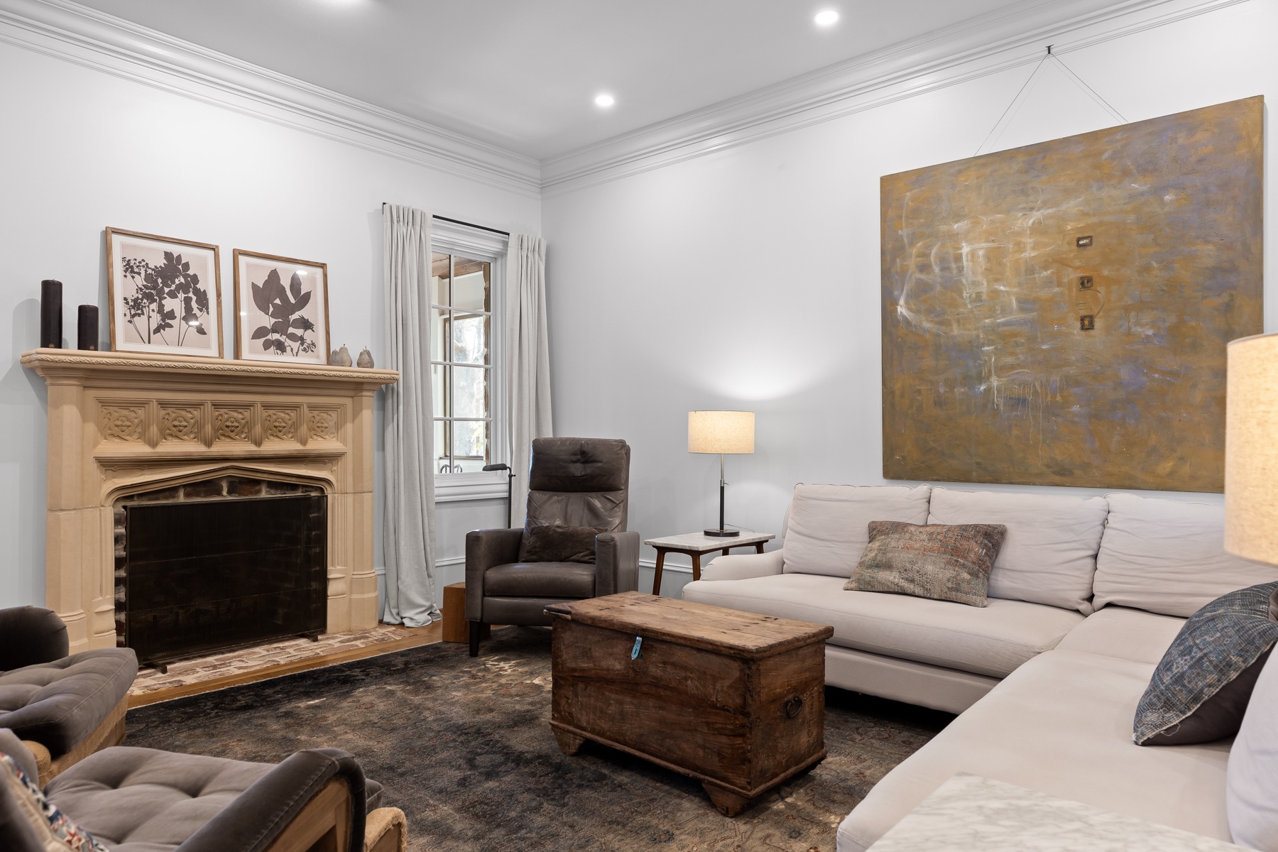 Cloudland Station living room with a carved stone fireplace and white seating